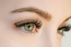 Close up view of beautiful green female eye with long eyelashes,