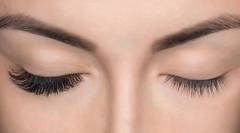 Eyelash removal procedure close up. Beautiful Woman with long la